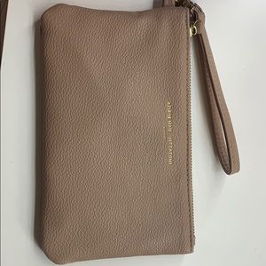 Tan wristlet with portable charger on the inside